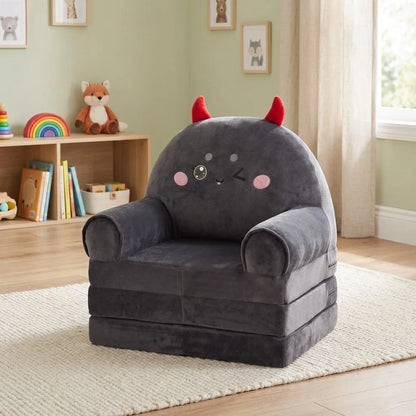 Fauteuil enfant gris en peluche, motif diable au visage, accoudoirs arrondis, coussin
