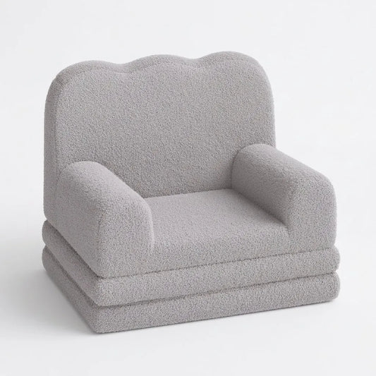 Fauteuil enfant gris à texture pelucheuse, accoudoirs arrondis et assise en couches