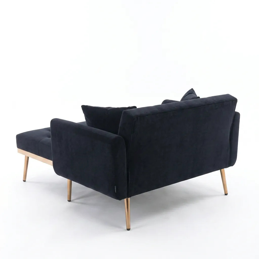 Canapé convertible en tissu bleu foncé, assise dépliée, pieds fins en bois, coussins.