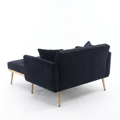 Canapé convertible en tissu bleu foncé, assise dépliée, pieds fins en bois, coussins.