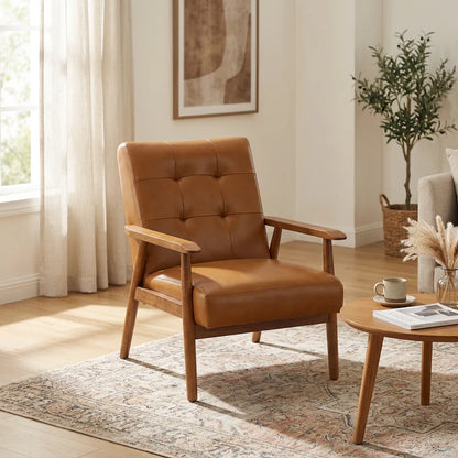 Fauteuil en cuir brun à dossier capitonné, accoudoirs, piètement en noyer.