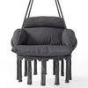 Fauteuil suspendu en macramé sombre, coussin épais, accoudoirs arrondis, franges